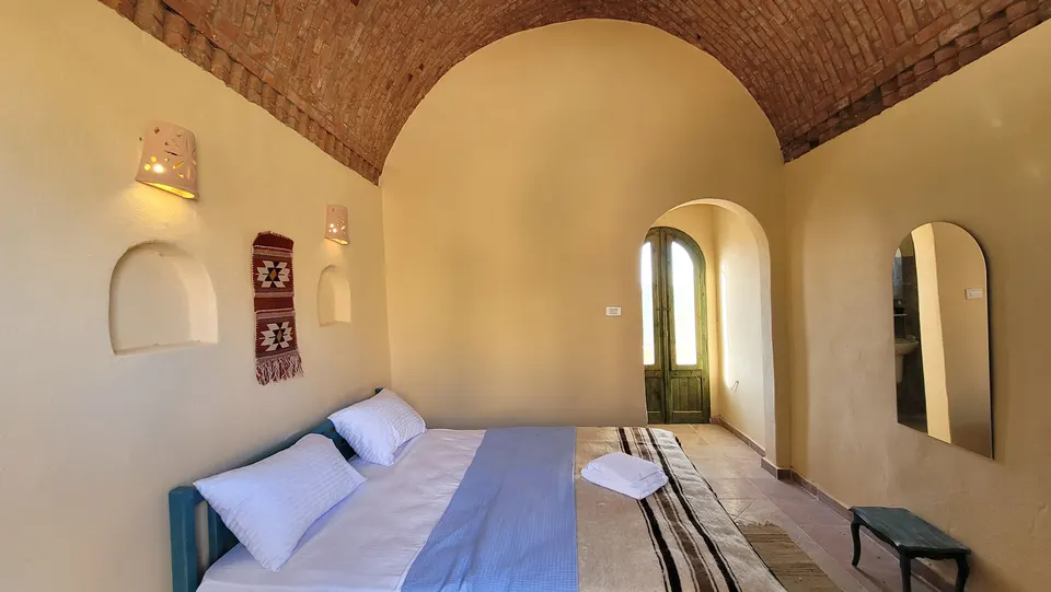 Beds beneath a vaulted brick ceiling · Standard